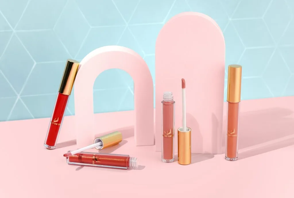 Lipstick, eyeshadow and foundation arranged on a vanity